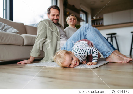 Happy family playing together at home. 126844322
