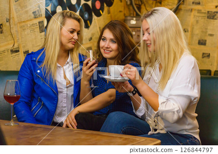 Girls in club talking drinking alcohol 126844797