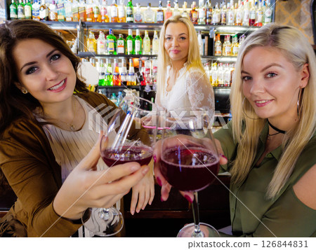 Girls with alcohol glasses in pub club 126844831