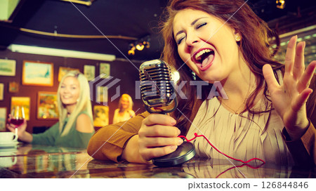 Woman singing with microphone 126844846