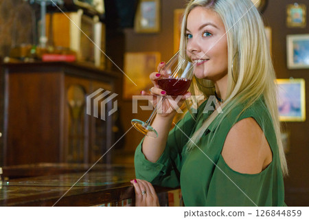 Girl with alcohol glass in pub club Girl with alcohol glass in pub club 126844859