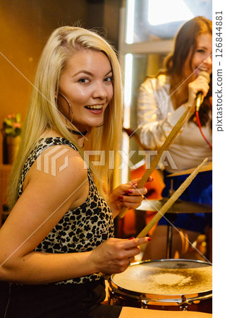 Woman singing, band playing instruments. 126844881