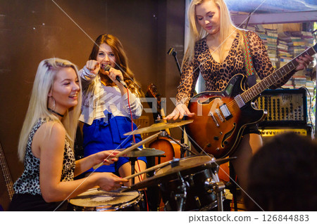 Woman singing, band playing instruments. Woman singing, band playing instruments. 126844883