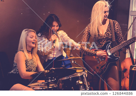 Woman singing, band playing instruments. Woman singing, band playing instruments. 126844886