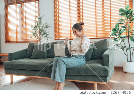 Funny euphoric young asian woman celebrating winning 126844996