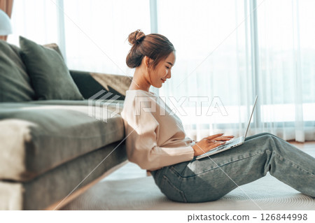 Young Asian beautiful woman relaxing on comfortable couch Young Asian beautiful woman relaxing on comfortable couch 126844998