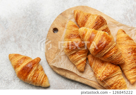 Freshly baked croissants on wooden board 126845222