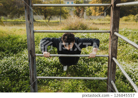 Man Works Out in Spring Outdoors Doing Push Ups Sport Exercise 126845557