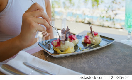 Hand Of A Woman Picking The Fork To Eat The Gourmet Fish Lunch  126845604