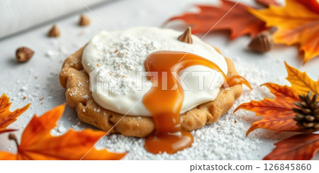 Delicious autumn dessert featuring caramel, whipped cream, and colorful fall leaves 126845860