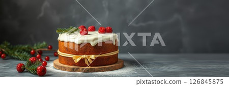 Delicious festive cake decorated with red berries and greenery on wooden board for holiday celebration Delicious festive cake decorated with red berries and greenery on wooden board for holiday celebration 126845875