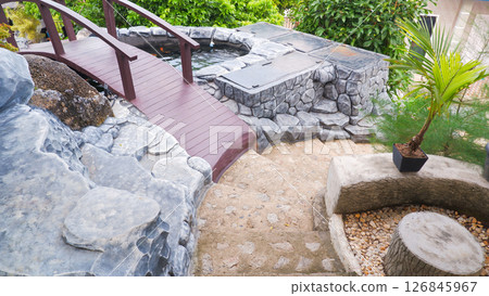 Modern Stone Garden Pathway with Wooden Bridge and Outdoor Jacuzzi 126845967