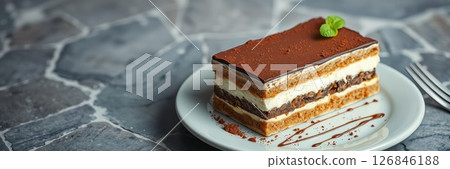 Delicious layered dessert with chocolate and cream served on a white plate 126846188