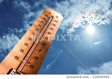 Thermometer showing tropical heat and sky with hot sun rays in Celsius and Fahrenheit 126846494