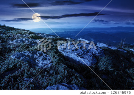 scenic view of alpine landscape in summer at night. peaceful nature environment with green meadow and rock for travel. hiking through wonderful carpathian alps in full moon light. amazing vacation in 126846976