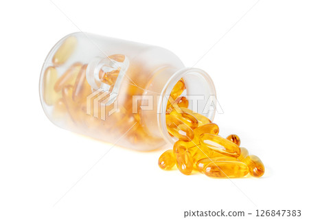 Frosted glass jar tipped over with golden fish oil softgel capsules spilling out isolated on white background Frosted glass jar tipped over with golden fish oil softgel capsules spilling out isolated on white background 126847383