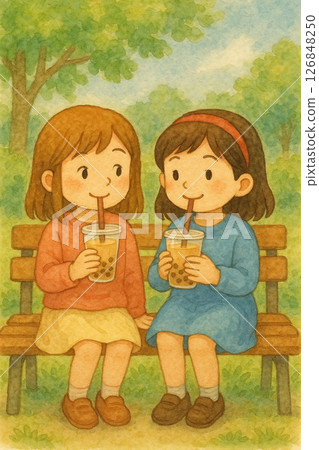公園のベンチでタピオカを楽しむ女の子たち Two girls enjoying bubble tea 126848250