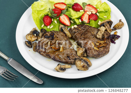 Piece of roast beef with strawberries. Piece of roast beef with strawberries. 126848277