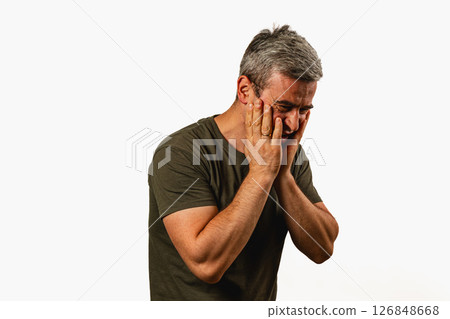 Man showing signs of distress in a neutral setting Man showing signs of distress in a neutral setting 126848668