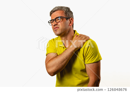 Man experiencing shoulder discomfort in a studio setting Man experiencing shoulder discomfort in a studio setting 126848676
