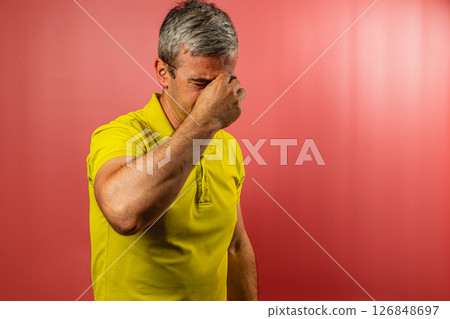 Frustrated man expressing emotions against a solid background 126848697