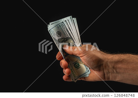 Hand holding cash in a dark environment at night Hand holding cash in a dark environment at night 126848748