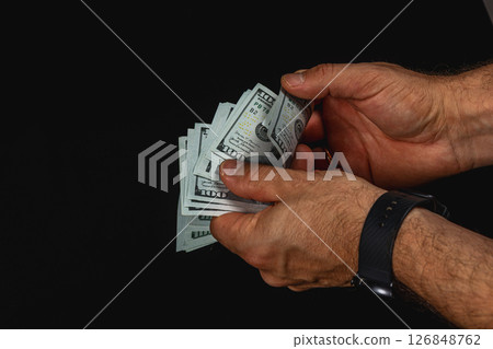 Hands counting cash in low light setting 126848762