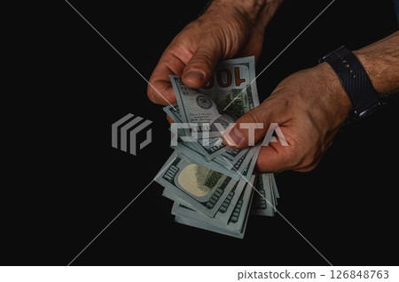 Person counting cash in dim lighting at night 126848763