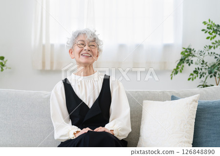 Senior woman sitting on sofa Senior woman sitting on sofa 126848890