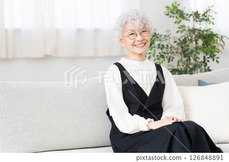 Senior woman sitting on sofa 126848891