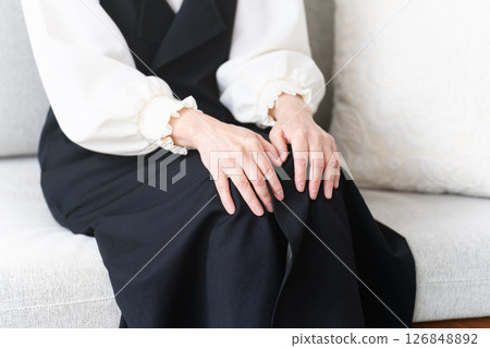 Senior woman sitting on sofa 126848892