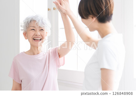 Young and senior women doing yoga, healthy image Young and senior women doing yoga, healthy image 126848908