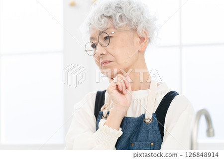 Senior woman standing in the kitchen Cooking image 126848914
