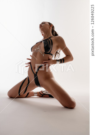 Brunette pole dancer stuns with body art and flexibility Brunette pole dancer stuns with body art and flexibility 126849225