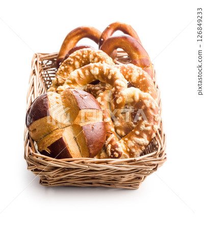 Salted bavarian pretzels and buns isolated on white background. 126849233