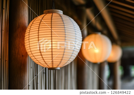 Asian Paper Lanterns Hanging in a Bamboo Structure 126849422