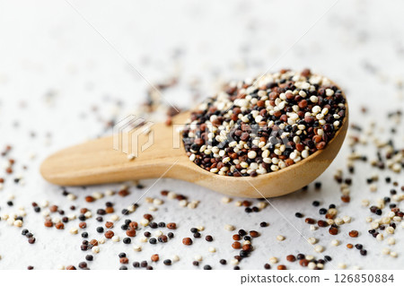 Mix of white, black and red quinoa seeds in wooden spoon. Mix of white, black and red quinoa seeds in wooden spoon. 126850884