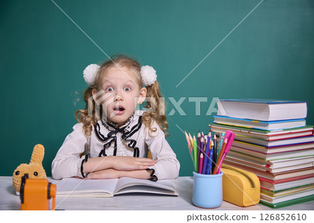 Surprised Child with Books and School Supplies Surprised Child with Books and School Supplies 126852610