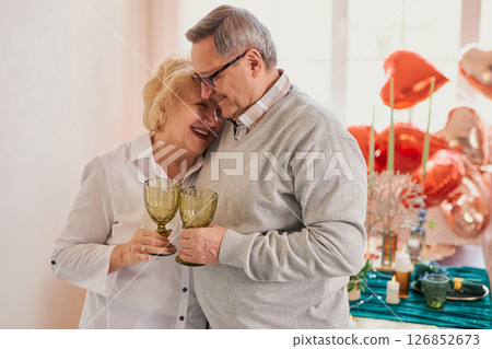 Romantic senior couple celebrating at home 126852673