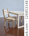 Minimalist Wooden Chair and Table Set on Wooden Surface 126853148
