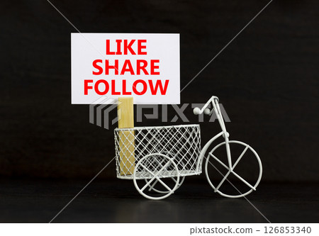 Like share follow symbol. Concept words Like Share Follow on beautiful white paper on clothespin. Beautiful black background. Miniature white bicycle. Business like share follow concept. Copy space. Like share follow symbol. Concept words Like Share Follow on beautiful white paper on clothespin. Beautiful black background. Miniature white bicycle. Business like share follow concept. Copy space. 126853340