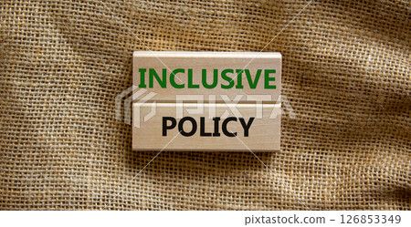 Inclusive policy symbol. Wooden blocks with words Inclusive policy on beautiful canvas background. Business, HR and inclusive policy concept. Copy space. Inclusive policy symbol. Wooden blocks with words Inclusive policy on beautiful canvas background. Business, HR and inclusive policy concept. Copy space. 126853349