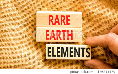 Rare earth elements symbol. Concept words Rare earth elements on beautiful wooden block. Businessman's hand. Beautiful canvas background. Business and rare earth elements concept. Copy space. 126853379