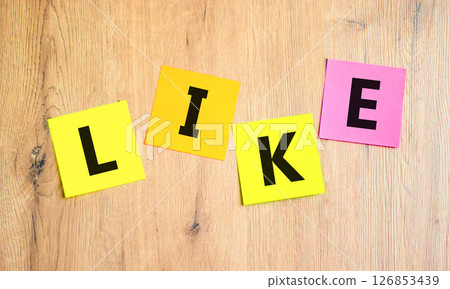 Like symbol. Concept word Like on beautiful colored paper. Beautiful wooden table wooden background. Business, lifestyle, support and like concept. Copy space. Like symbol. Concept word Like on beautiful colored paper. Beautiful wooden table wooden background. Business, lifestyle, support and like concept. Copy space. 126853439