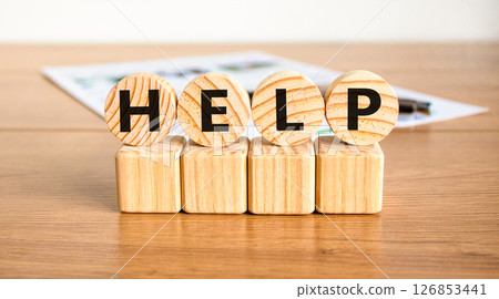 Help symbol. Concept word Help on beautiful wooden circles on wooden blocks. Beautiful wooden table white background. Business, lifestyle, support and help concept. Copy space. 126853441