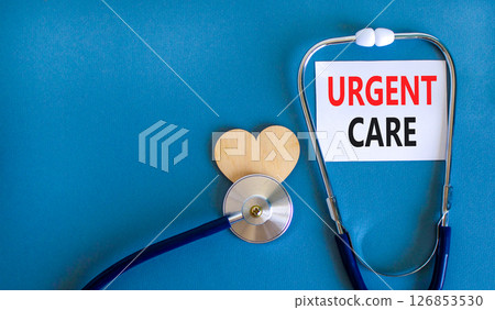 Urgent care symbol. Concept words Urgent care on beautiful white card. Wooden heart and stethoscope. Beautiful blue background. Medical healthy lifestyle urgent care concept. Urgent care symbol. Concept words Urgent care on beautiful white card. Wooden heart and stethoscope. Beautiful blue background. Medical healthy lifestyle urgent care concept. 126853530