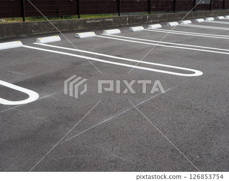 Scenery with road markings, a scene from a parking lot, space for small cars, copy space, curbs are also important Scenery with road markings, a scene from a parking lot, space for small cars, copy space, curbs are also important 126853754