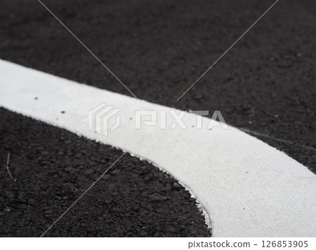 Shadows drawn on the road surface, image of a parking lot, copy space. Feel the scenery of a car space under the blue sky. 126853905