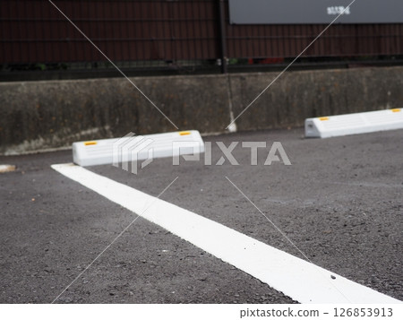 Shadows drawn on the road surface, image of a parking lot, copy space. Feel the scenery of a car space under the blue sky. 126853913