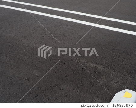 Shadows drawn on the road surface, image of a parking lot, copy space. Feel the scenery of a car space under the blue sky. 126853970